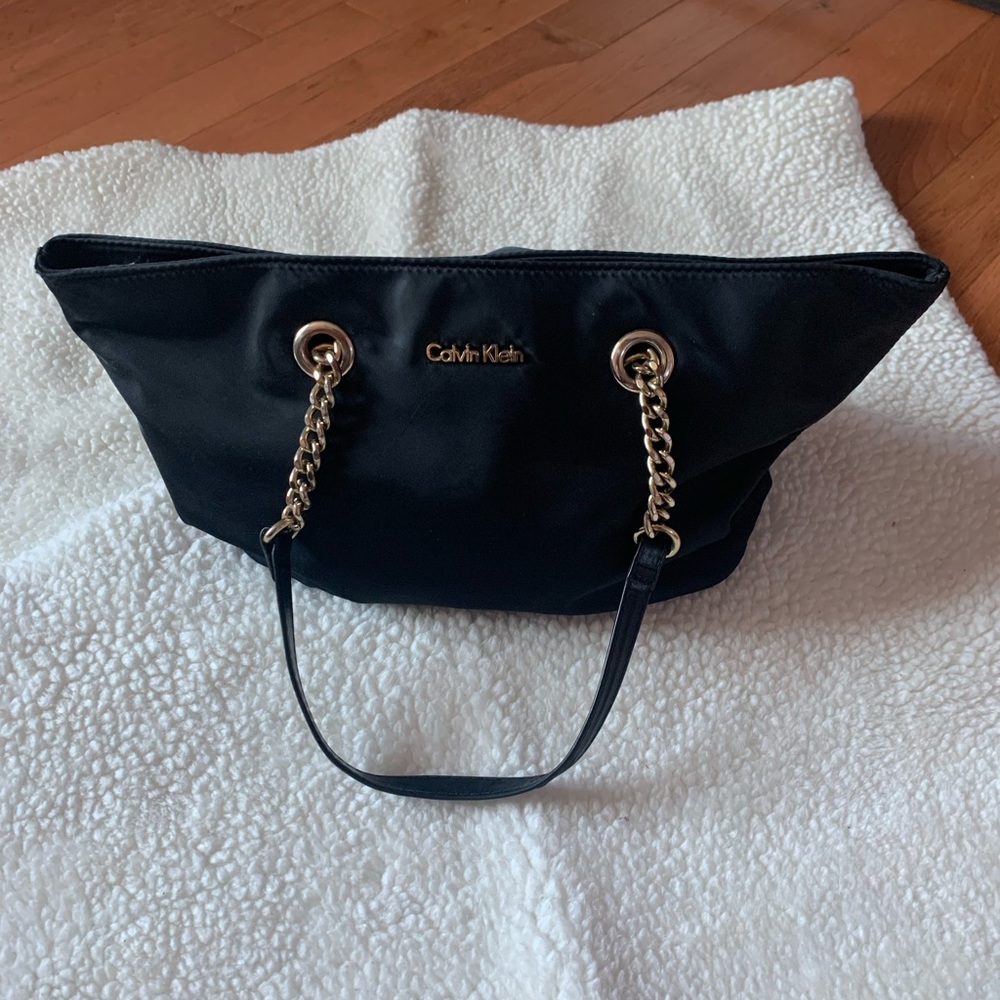 Black Calvin Klein tote purse, medium size with a zipper and leather handles